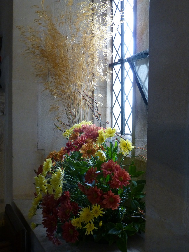 Wheat with yellow and orange flowers